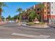 Elegant entrance featuring a landscaped roundabout and a gate at 75 E Agate Ave # 206, Las Vegas, NV 89123