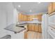 Close-up of kitchen, showcasing wood cabinets, granite counters, and appliances at 75 E Agate Ave # 206, Las Vegas, NV 89123