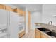 Well-lit kitchen featuring modern appliances, wooden cabinets, and granite countertops at 75 E Agate Ave # 206, Las Vegas, NV 89123