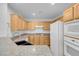 Kitchen featuring wood cabinets, granite countertops and appliances at 75 E Agate Ave # 206, Las Vegas, NV 89123