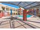 Inviting outdoor pool area with lounge chairs, umbrellas, and lush landscaping at 75 E Agate Ave # 206, Las Vegas, NV 89123
