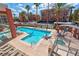 Beautiful pool area with plenty of lounge seating, a hot tub, and surrounded by mature palm trees at 75 E Agate Ave # 206, Las Vegas, NV 89123