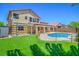 Home exterior showcasing an in-ground swimming pool, covered patio, and turf at 7619 Comanche Canyon Ave, Las Vegas, NV 89113