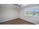 Bedroom with natural light from a window, ceiling fan and wood-look flooring at 7619 Comanche Canyon Ave, Las Vegas, NV 89113