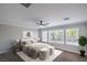 Bright bedroom with three windows and a ceiling fan, styled with neutral decor at 7619 Comanche Canyon Ave, Las Vegas, NV 89113