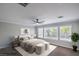 Serene bedroom with large windows, ceiling fan, and neutral color palette at 7619 Comanche Canyon Ave, Las Vegas, NV 89113