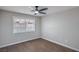 Minimalist bedroom with modern ceiling fan, neutral walls, and hardwood floors at 7619 Comanche Canyon Ave, Las Vegas, NV 89113