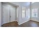 Bright entryway with double doors, hardwood floors and three windows with white blinds at 7619 Comanche Canyon Ave, Las Vegas, NV 89113
