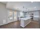 Bright kitchen features an island with white countertop, gray cabinets, and stainless-steel appliances at 7619 Comanche Canyon Ave, Las Vegas, NV 89113