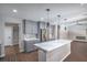 Bright, open kitchen with gray cabinets, stainless appliances, and a marble island at 7619 Comanche Canyon Ave, Las Vegas, NV 89113