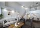 Spacious living room with high ceilings, hardwood floors, modern decor, and access to the dining area at 7619 Comanche Canyon Ave, Las Vegas, NV 89113