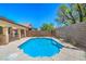Backyard with an in-ground pool, hardscape and a block wall at 7619 Comanche Canyon Ave, Las Vegas, NV 89113