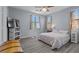 Comfortable bedroom with wood-look flooring, a ceiling fan, and two windows at 7818 Brodie Castle Ct, Las Vegas, NV 89166