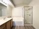Bathroom with tub-shower combo, stylish vanity, and neutral tile at 7830 Foxwood Pl # 7830, Las Vegas, NV 89145