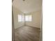 Cozy bedroom with newer laminate floors and natural light from two windows at 7830 Foxwood Pl # 7830, Las Vegas, NV 89145