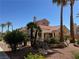 Community clubhouse with tile roof, desert landscaping, and rock waterfall feature at 7830 Foxwood Pl # 7830, Las Vegas, NV 89145