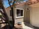 Close up shot of a home entrance featuring a security door, window, and desert landscaping at 7830 Foxwood Pl # 7830, Las Vegas, NV 89145