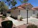 Attractive home featuring a two-car garage, desert landscaping, and a terracotta tile roof at 7830 Foxwood Pl # 7830, Las Vegas, NV 89145