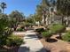 A tree-lined walkway through a landscaped residential community at 7830 Foxwood Pl # 7830, Las Vegas, NV 89145