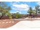 Expansive backyard featuring desert landscaping, mature trees, and a stone pathway at 786 Craigmark Ct, Henderson, NV 89002