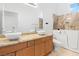 Modern bathroom featuring double sinks, granite counters and accessible bathtub at 786 Craigmark Ct, Henderson, NV 89002