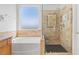 Bathroom featuring a soaking tub, and glass enclosed shower at 786 Craigmark Ct, Henderson, NV 89002
