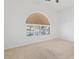 Neutral bedroom featuring tan carpeting and unique arch window at 786 Craigmark Ct, Henderson, NV 89002