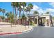 Community main entrance adorned with palm trees and rock columns with security check-in at 786 Craigmark Ct, Henderson, NV 89002