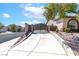 Long private driveway leading to a beautiful home with secure gate and lush landscaping at 786 Craigmark Ct, Henderson, NV 89002