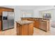 Well-equipped kitchen with granite counters, stainless steel fridge, and functional island at 786 Craigmark Ct, Henderson, NV 89002
