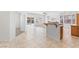 Open-concept kitchen with tile flooring, counter seating, and modern appliances at 786 Craigmark Ct, Henderson, NV 89002