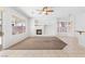 Open-concept living room with fireplace and ceiling fan at 786 Craigmark Ct, Henderson, NV 89002