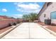 Spacious concrete parking area with well-maintained landscaping and a wall for privacy at 786 Craigmark Ct, Henderson, NV 89002