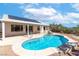 Backyard view of the beautiful pool with solar panels above the patio, surrounded by professionally landscaped areas at 786 Craigmark Ct, Henderson, NV 89002