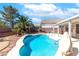 Inviting in-ground swimming pool with landscaped yard and palm trees at 786 Craigmark Ct, Henderson, NV 89002