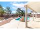 Covered patio overlooks an inviting in-ground swimming pool with landscaped yard at 786 Craigmark Ct, Henderson, NV 89002
