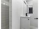 Compact bathroom featuring a modern vanity, mirror, and tiled shower at 809 Greenbrook St, Las Vegas, NV 89110