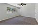 Carpeted bedroom features a ceiling fan, window with security bars, and plenty of space at 809 Greenbrook St, Las Vegas, NV 89110