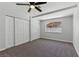 Neutral bedroom with a ceiling fan, carpet flooring, and closet with folding doors at 809 Greenbrook St, Las Vegas, NV 89110