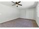 A bright carpeted bedroom with ceiling fan and closet offers comfort and style at 809 Greenbrook St, Las Vegas, NV 89110