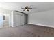 Neutral bedroom with a ceiling fan, carpet flooring, and access to bathroom at 809 Greenbrook St, Las Vegas, NV 89110