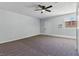 Neutral bedroom with a ceiling fan, carpet flooring, and access to exterior at 809 Greenbrook St, Las Vegas, NV 89110