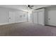 Neutral bedroom with a ceiling fan, carpet flooring, and access to exterior at 809 Greenbrook St, Las Vegas, NV 89110
