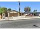 Single-story home with a spacious driveway, desert landscaping, and a charming gated front yard at 809 Greenbrook St, Las Vegas, NV 89110