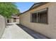 Exterior view showcasing the home's side, garage, and fenced security window at 809 Greenbrook St, Las Vegas, NV 89110