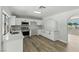 Modern kitchen with stainless steel appliances, white cabinets, and wood-look floors at 809 Greenbrook St, Las Vegas, NV 89110