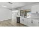 Bright kitchen with modern appliances, white cabinets, wood-look flooring, and dual sink at 809 Greenbrook St, Las Vegas, NV 89110