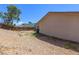 The spacious backyard features a rock surface area, with wooden fence, and a portion of the house wall at 824 Antigua St, Las Vegas, NV 89145