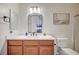 Modern bathroom featuring a brown vanity, a white marble countertop, and sleek fixtures, creating a serene atmosphere at 83 Buckthorn Ridge Ct, Las Vegas, NV 89183
