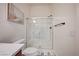 Contemporary bathroom with glass shower, a toilet, a brown vanity and an elegant white marble countertop at 83 Buckthorn Ridge Ct, Las Vegas, NV 89183